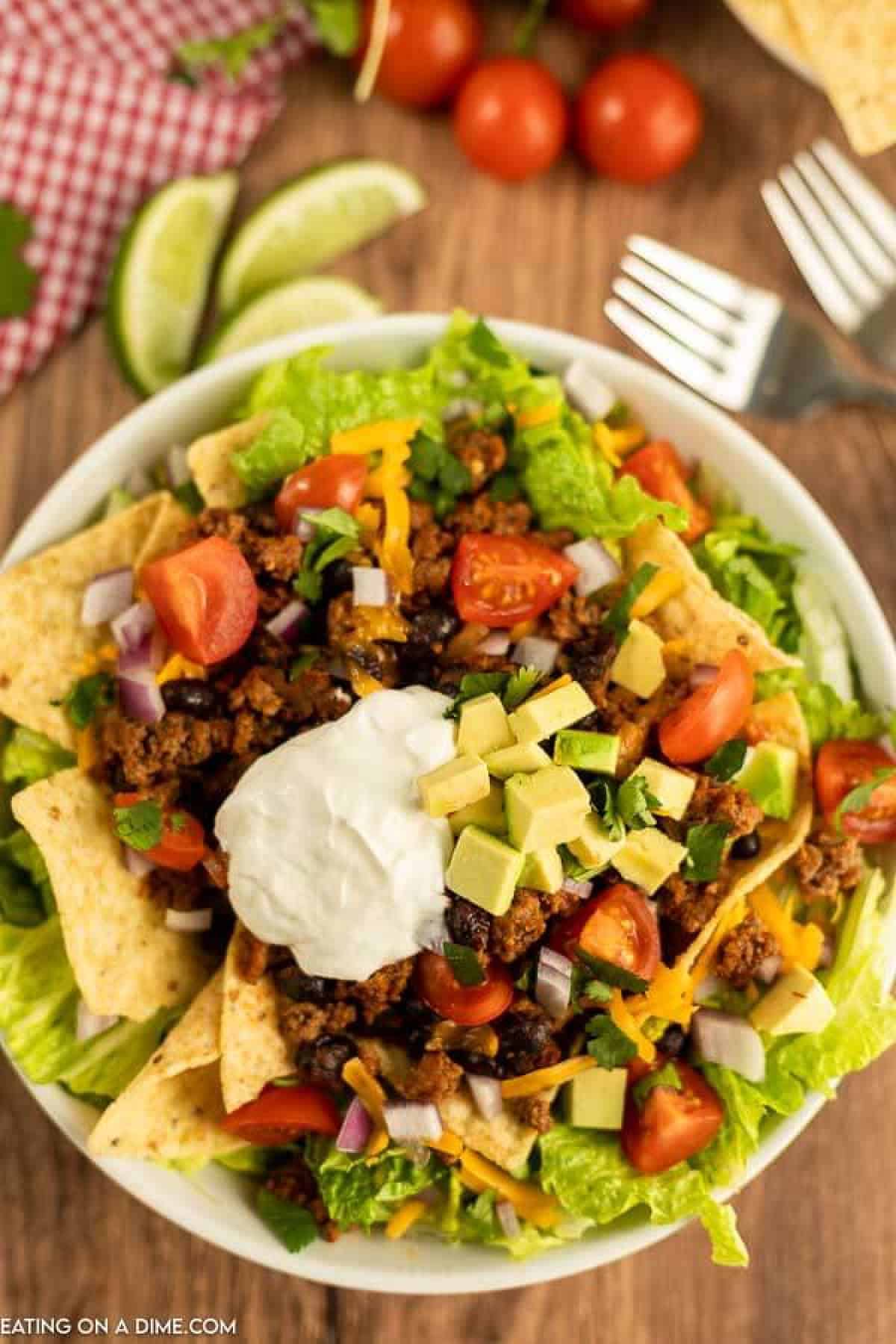 Close up image of taco salad on a white plate.