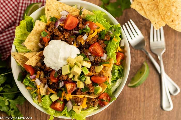 Close up image of taco salad on a white plate. 