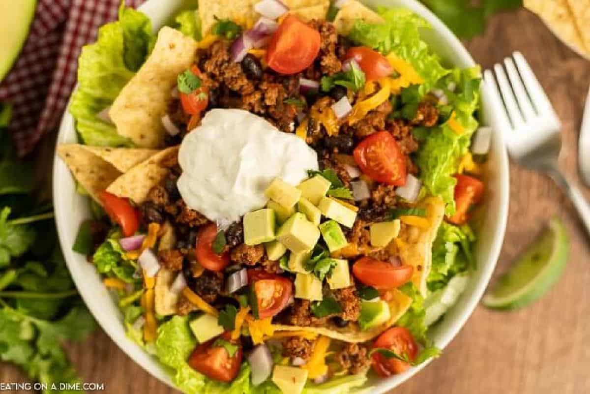 Close up image of taco salad on a white plate.