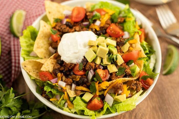 Close up image of taco salad on a white plate. 