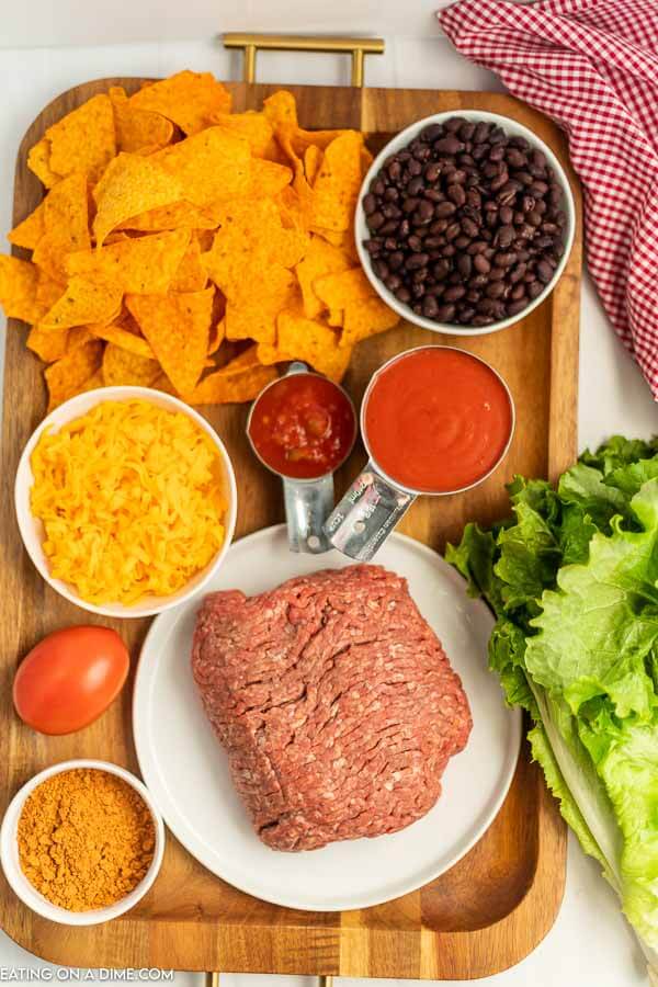 Ingredients needed - ground beef, taco seasoning, salsa, lettuce, black beans, tomato, cheese, doritos, catalina dressing