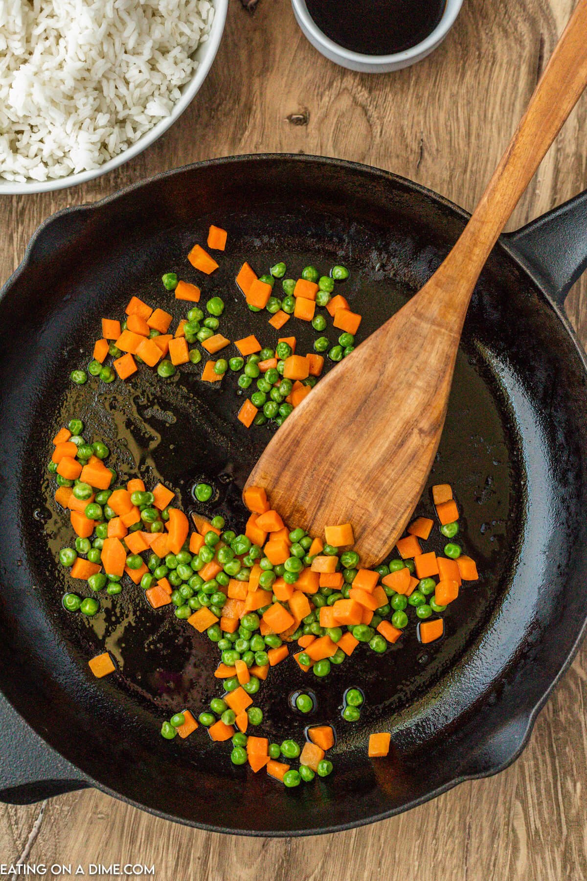 Cooking carrots and peas in a skillet