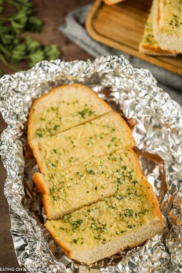 Slices of grilled garlic bread in foil. 