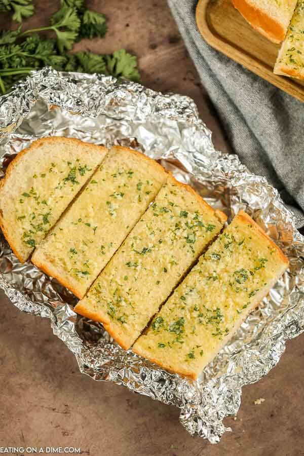 Slices of grilled garlic bread in foil. 
