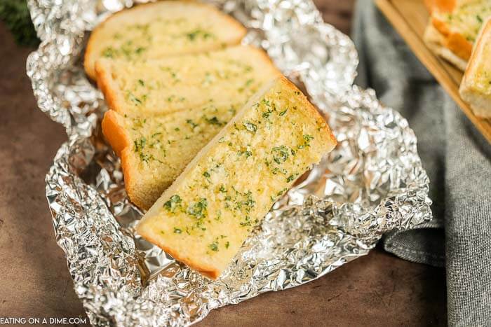 Slices of grilled garlic bread in foil. 