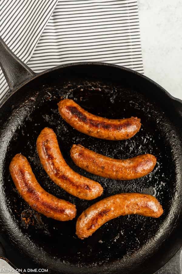 Close up image of italian sausage in a iron skillet. 