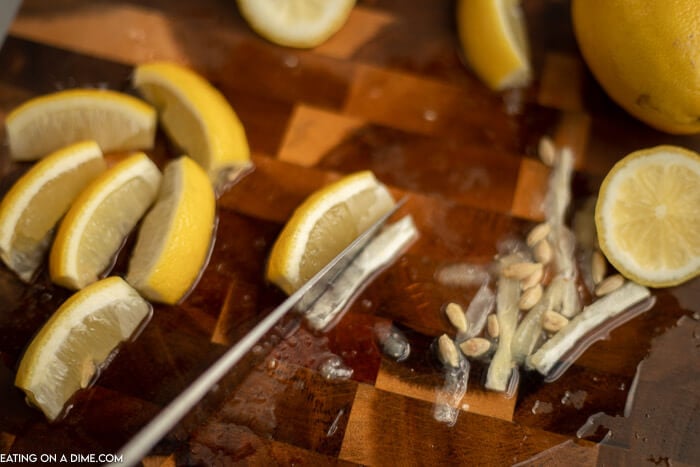 Close up image of lemon wedges with the core being cut off of the wedges. 