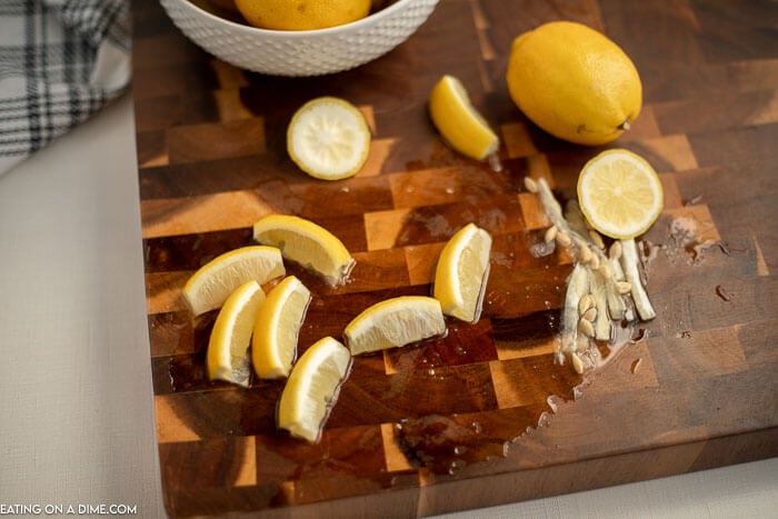 Close up image of lemon wedges with the core being cut off of the wedges. 