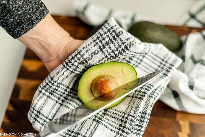 The process of removing the avocado pit with a knife 