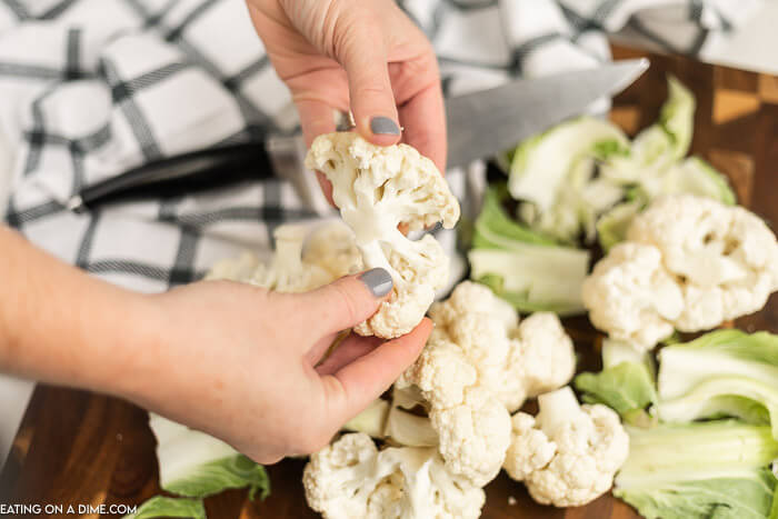 Cauliflower being held with two hands. 