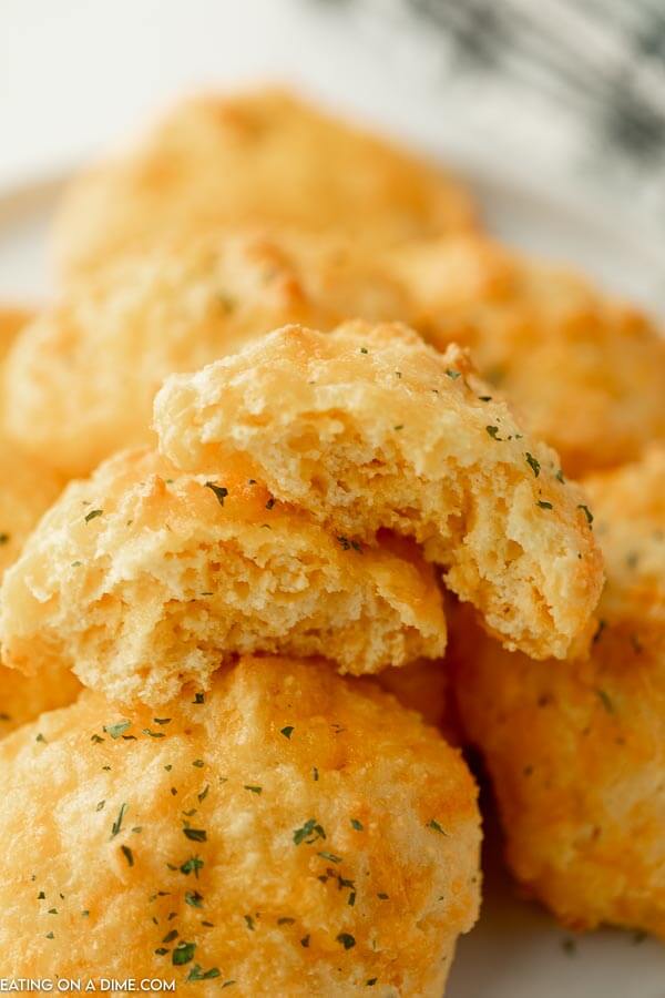 Close up image of keto cheddar biscuits  stacked. 