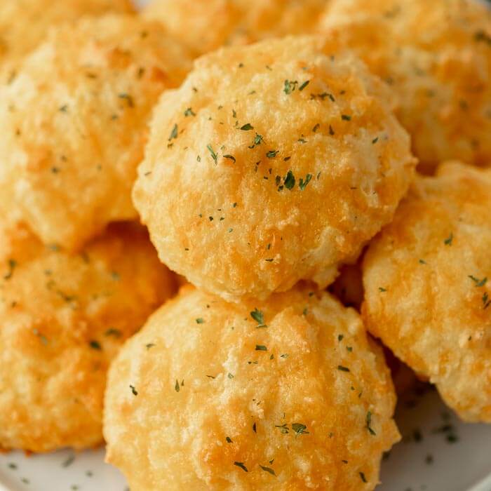 Close up image of keto cheddar biscuits  stacked. 