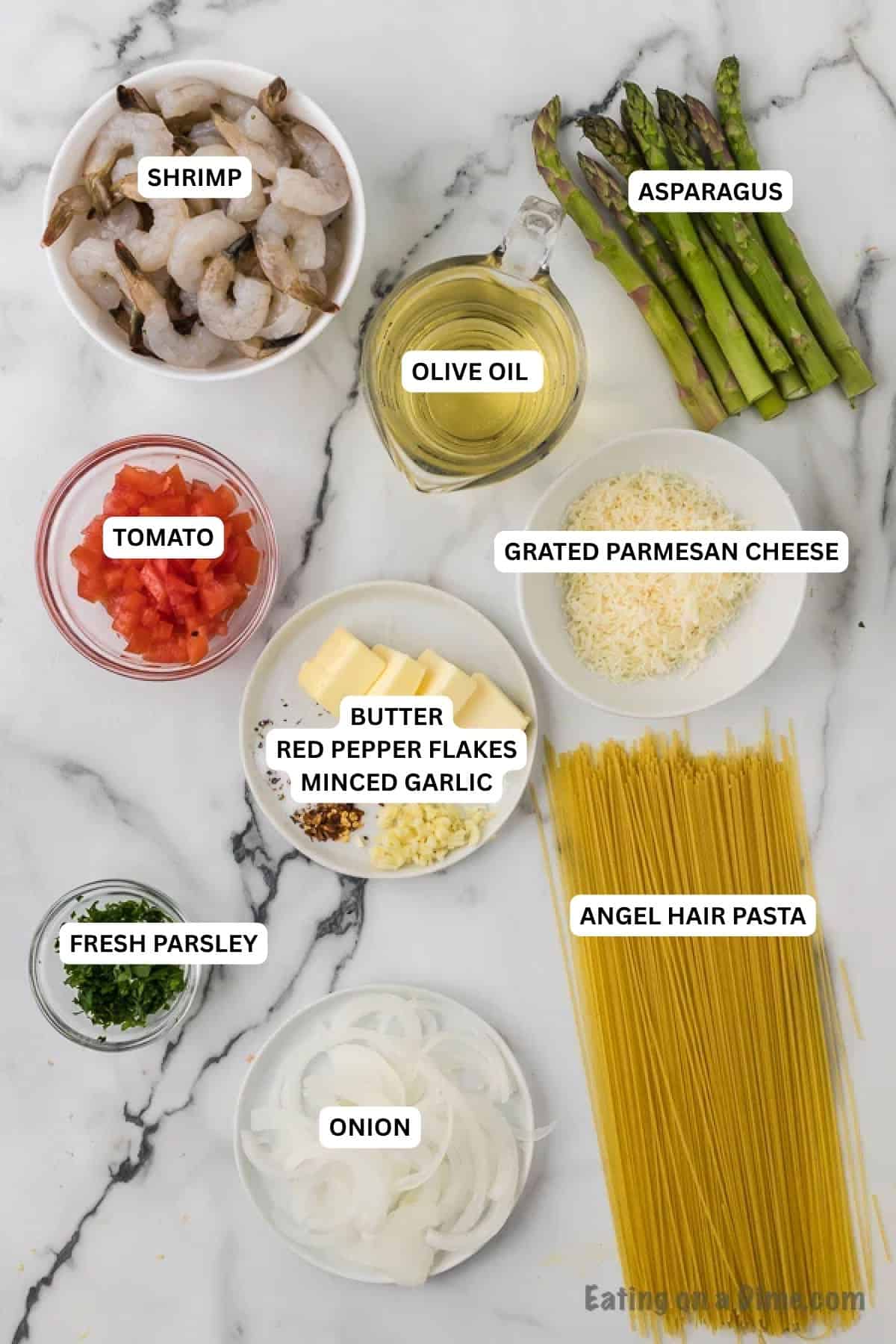 Ingredients for recipe: angel hair pasta, onion, fresh parsley, butter, red pepper flakes, minced garlic, tomato, oil, asparagus and shrimp.