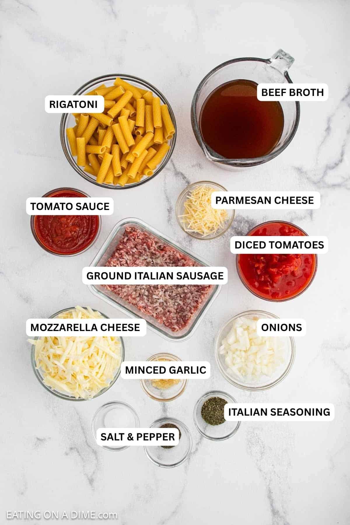 Ingredients for recipe: Italian seasoning, salt, pepper, minced garlic, onions, mozzarella cheese, ground Italian sausage, Parmesan cheese, tomato sauce, rigatoni and beef broth.