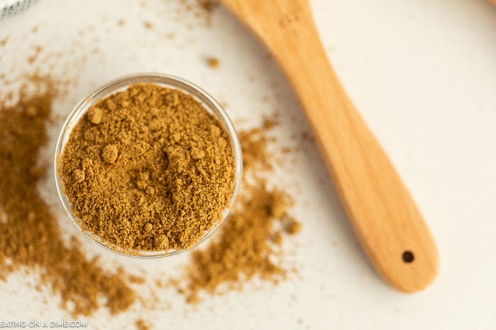 Close up image of ground cumin in a jar. 