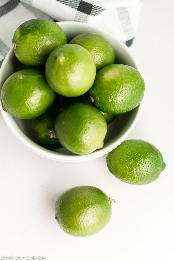 close up image of a bowl of whole limes