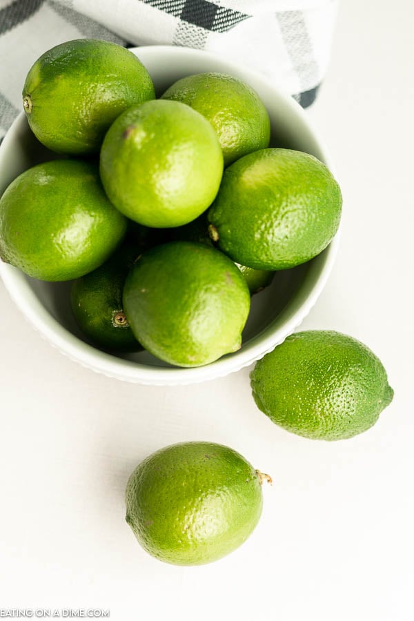 close up image of a bowl of whole limes