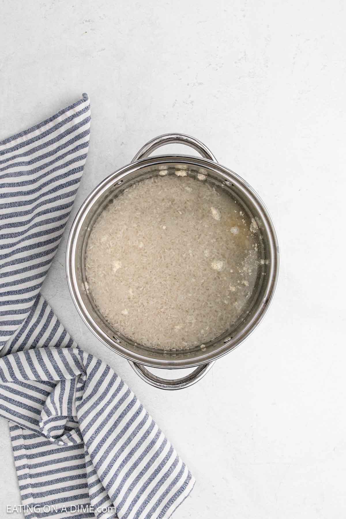 White rice in a large pot covered in water.