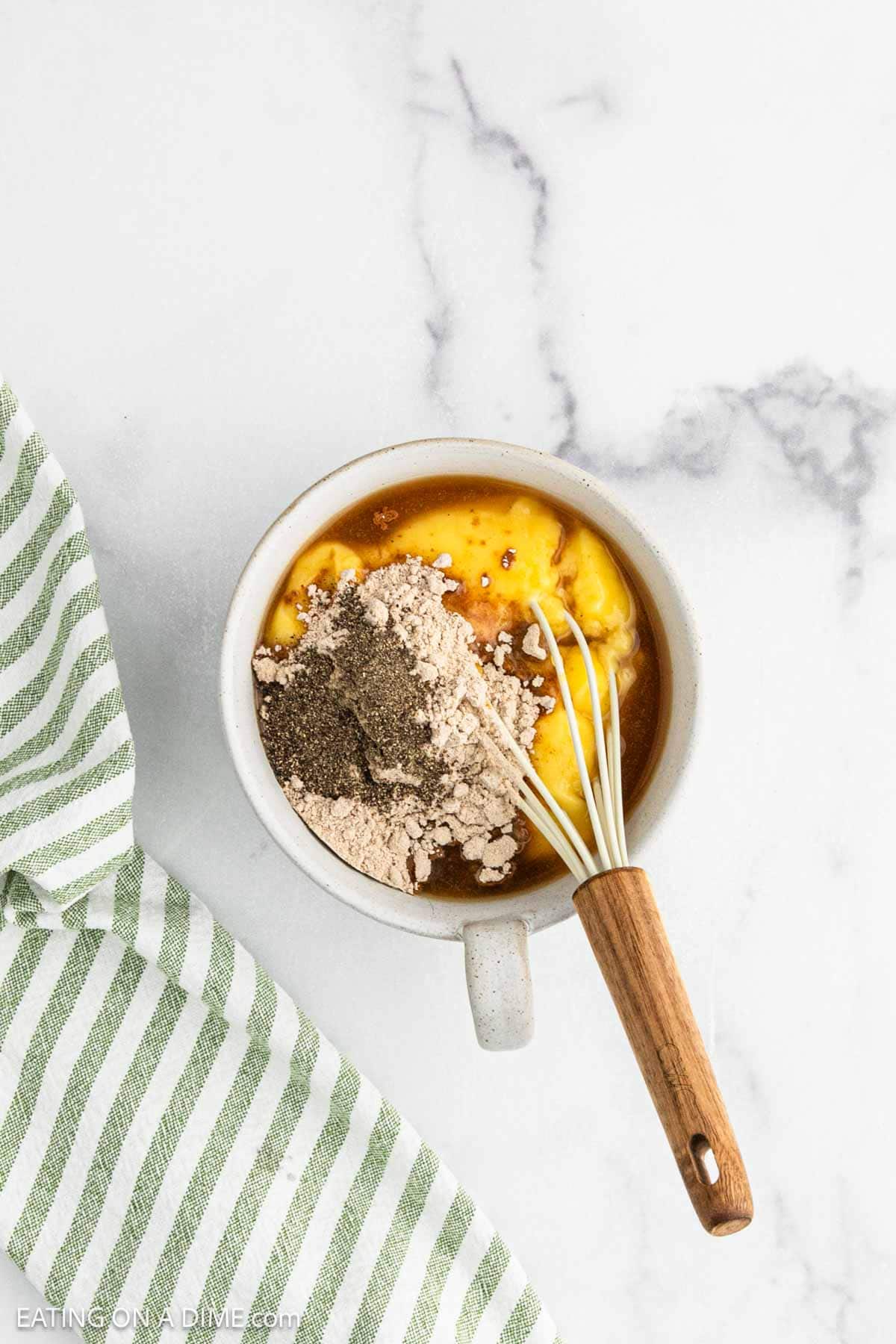 Combining the gravy ingredients in a bowl with a whisk