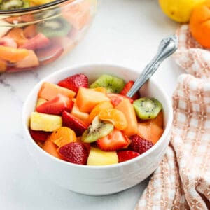 Fresh Fruit Salad in a white bowl.