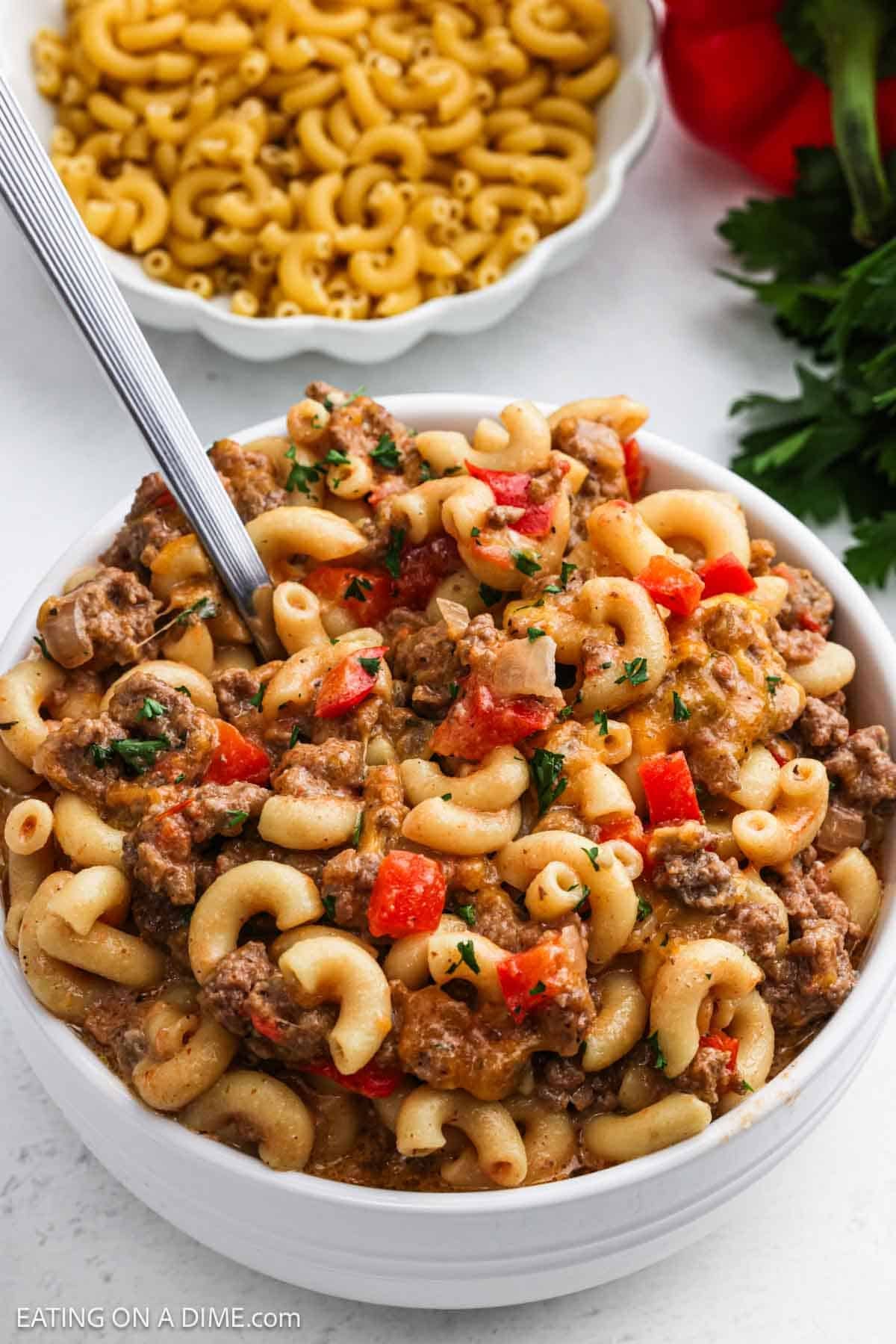 A serving of macaroni noodles and ground beef in a bowl.