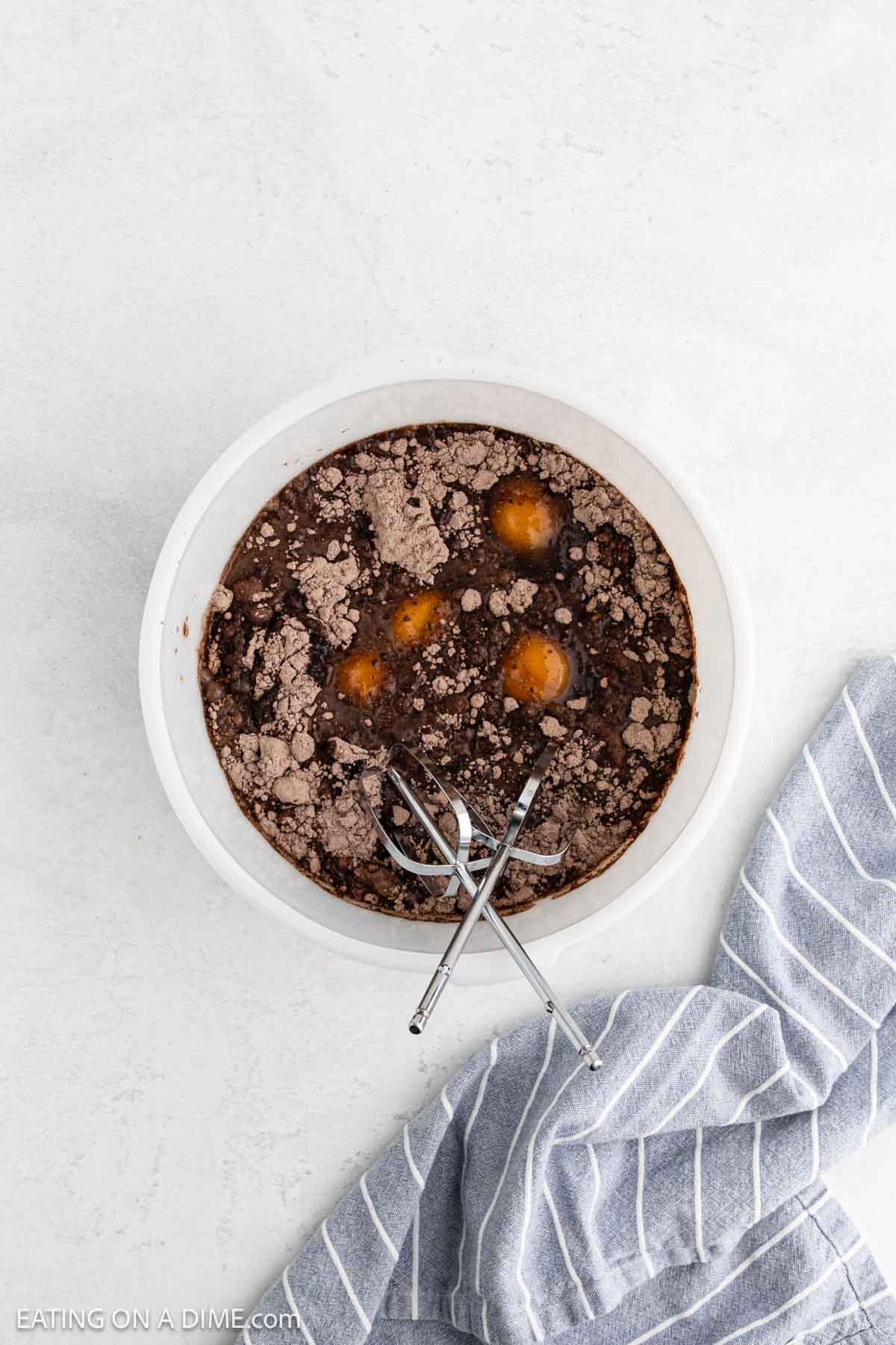 Combining the cake mix ingredients in a bowl