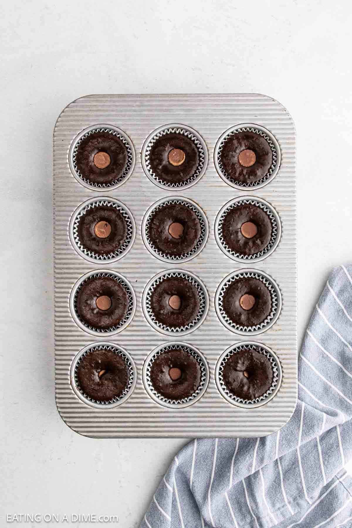 Cupcake topped with Reese's Peanut Butter Cup in a muffin pan