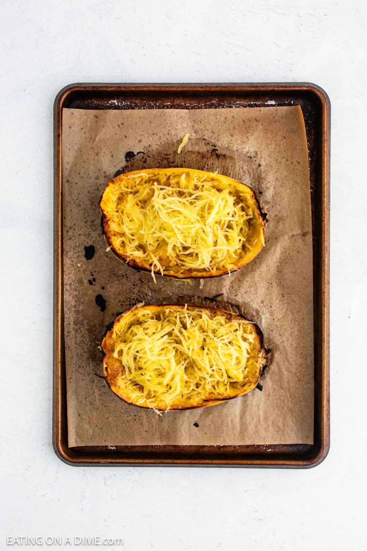 Cooked squash cooked into strands on a baking sheet.