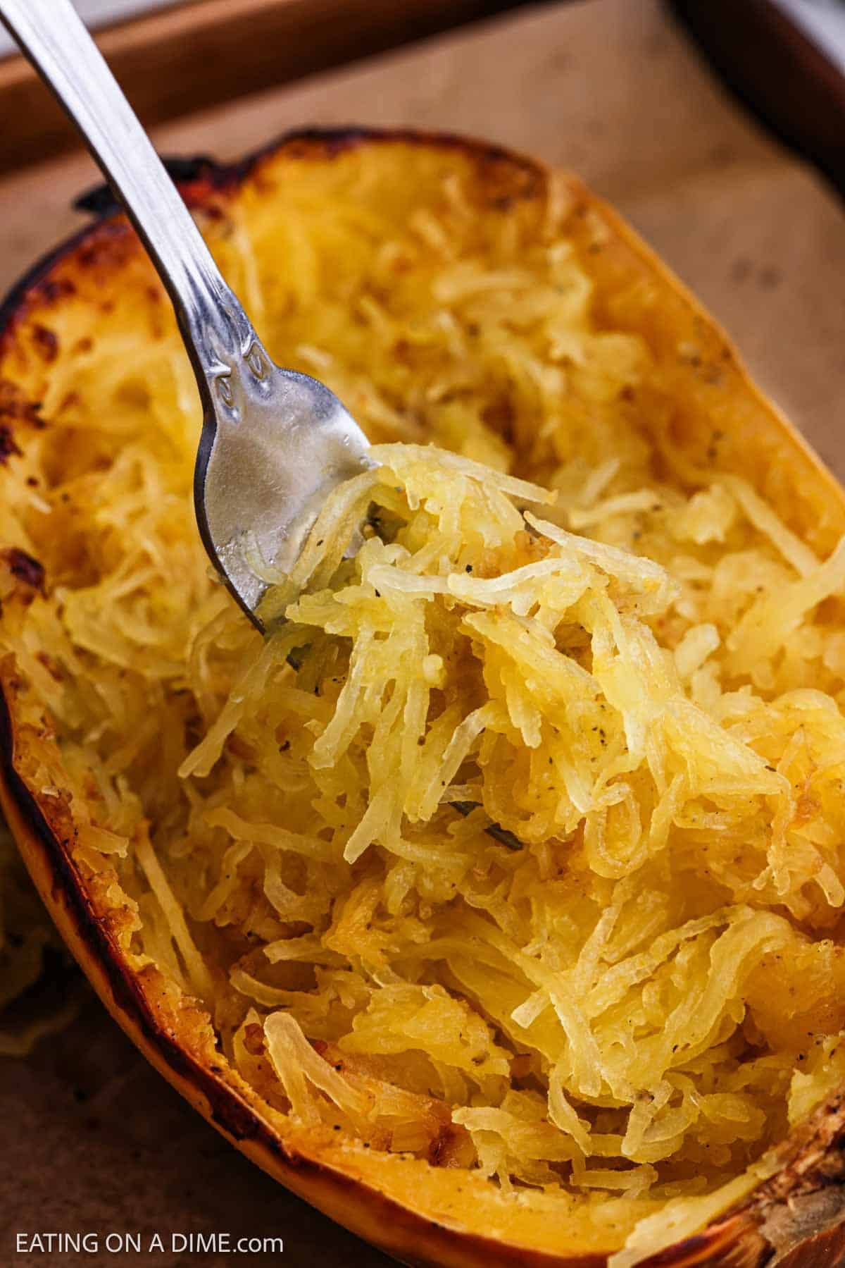 Cooked squash shredded into strands with a fork.