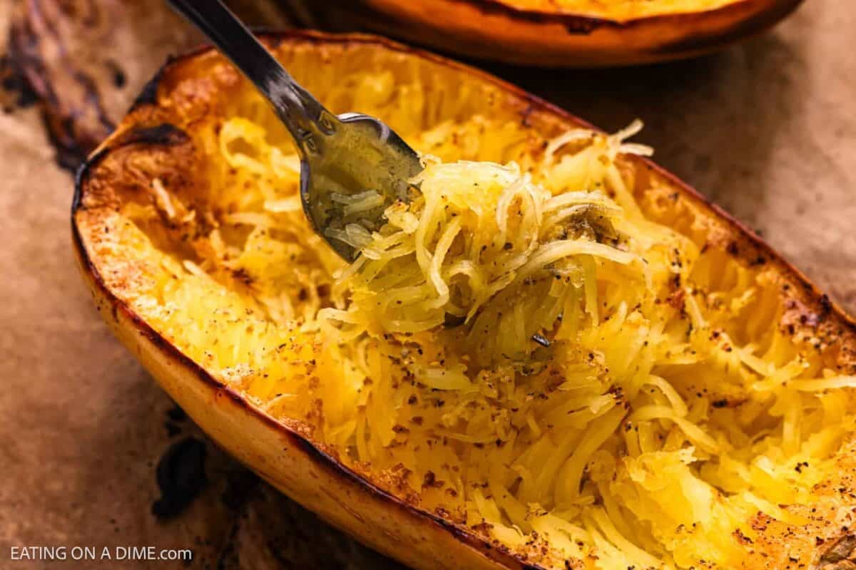 Roasted spaghetti squash with strands around a fork.