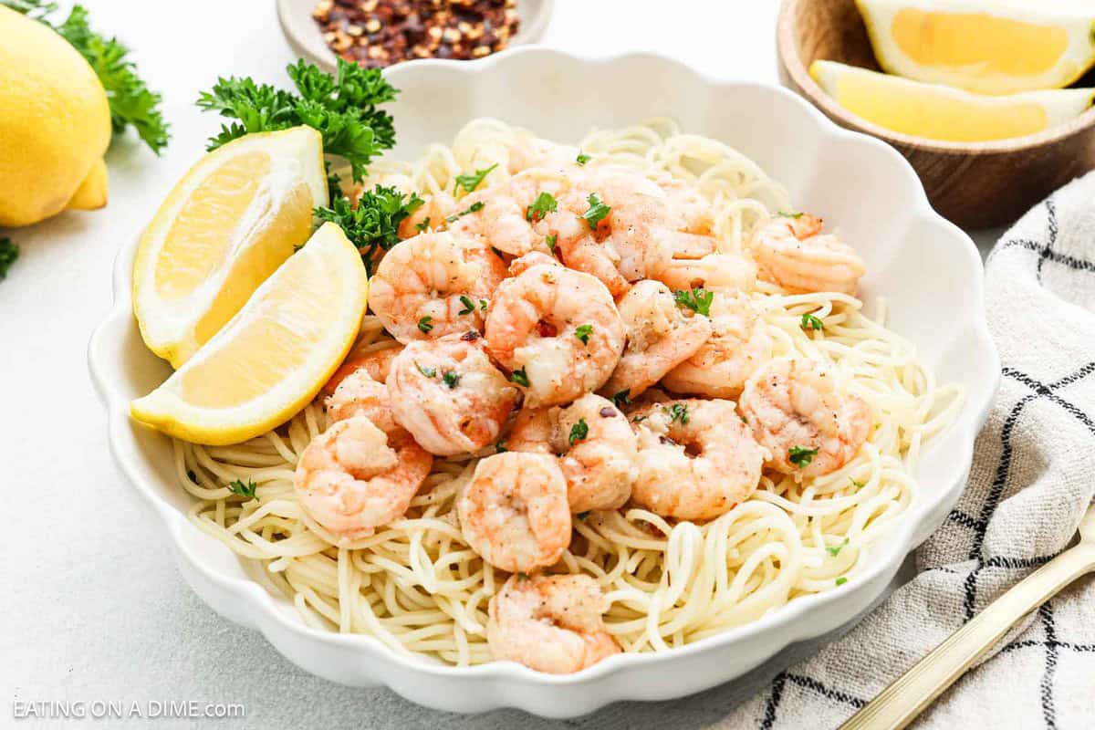 Shrimp scampi in a bowl over pasta.