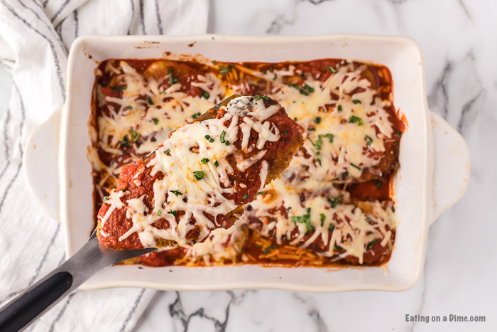 Chicken Parmesan in a white dish ready to serve.
