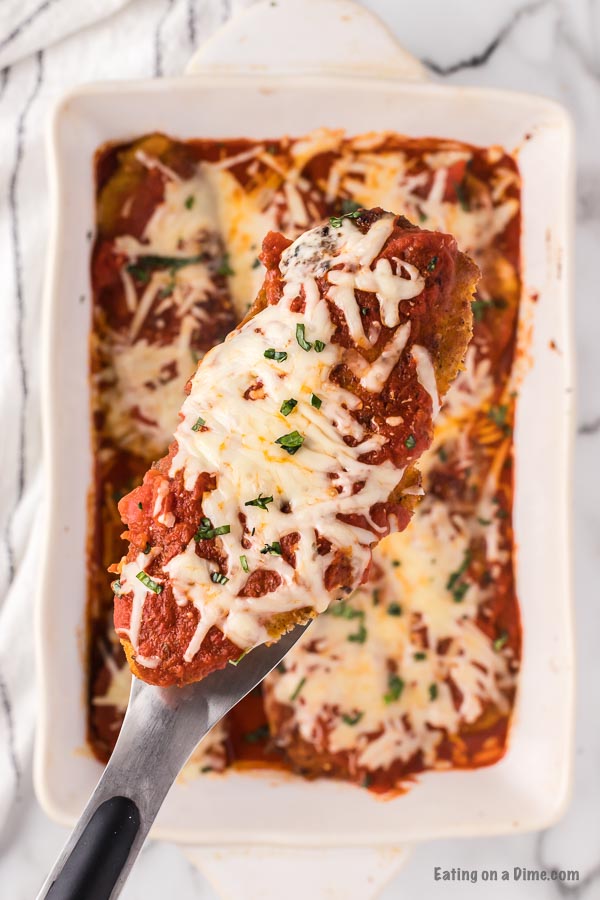 Chicken Parmesan in a white baking dish ready to serve. 