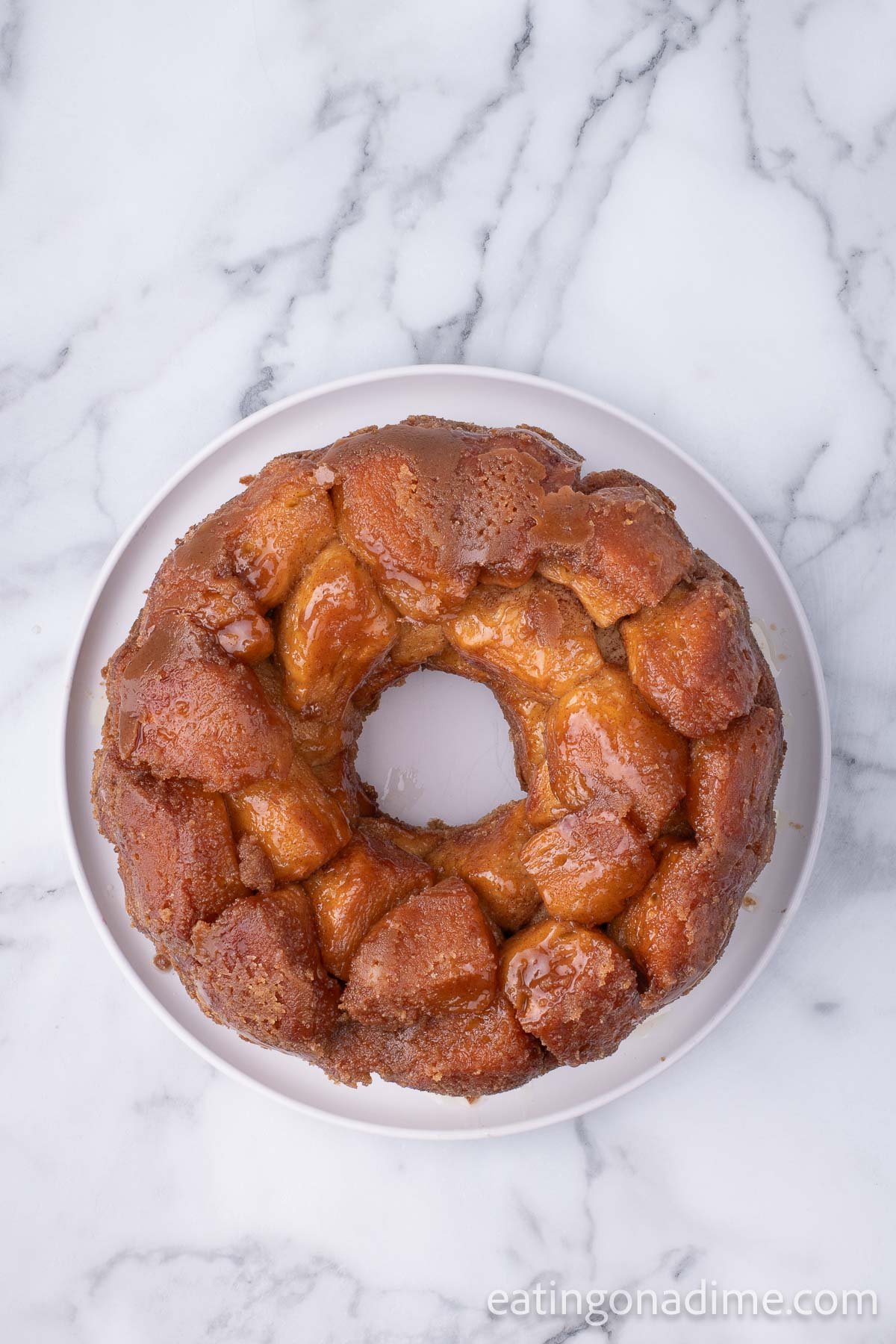 The monkey bread fully cooked and carefully inverted onto a serving plate.  