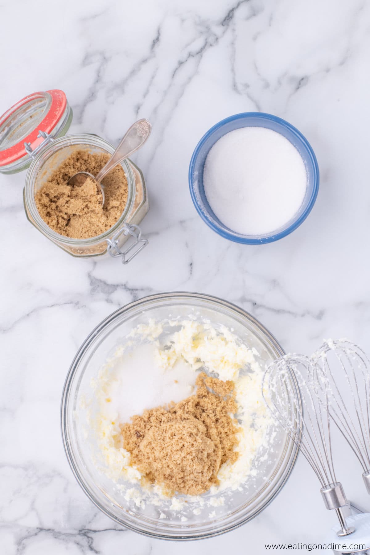 Brown sugar and white sugar in a bowl with softened butter.
