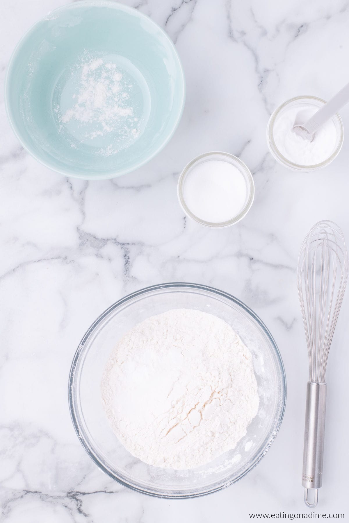 Flour, baking soda, and salt added to a bowl.