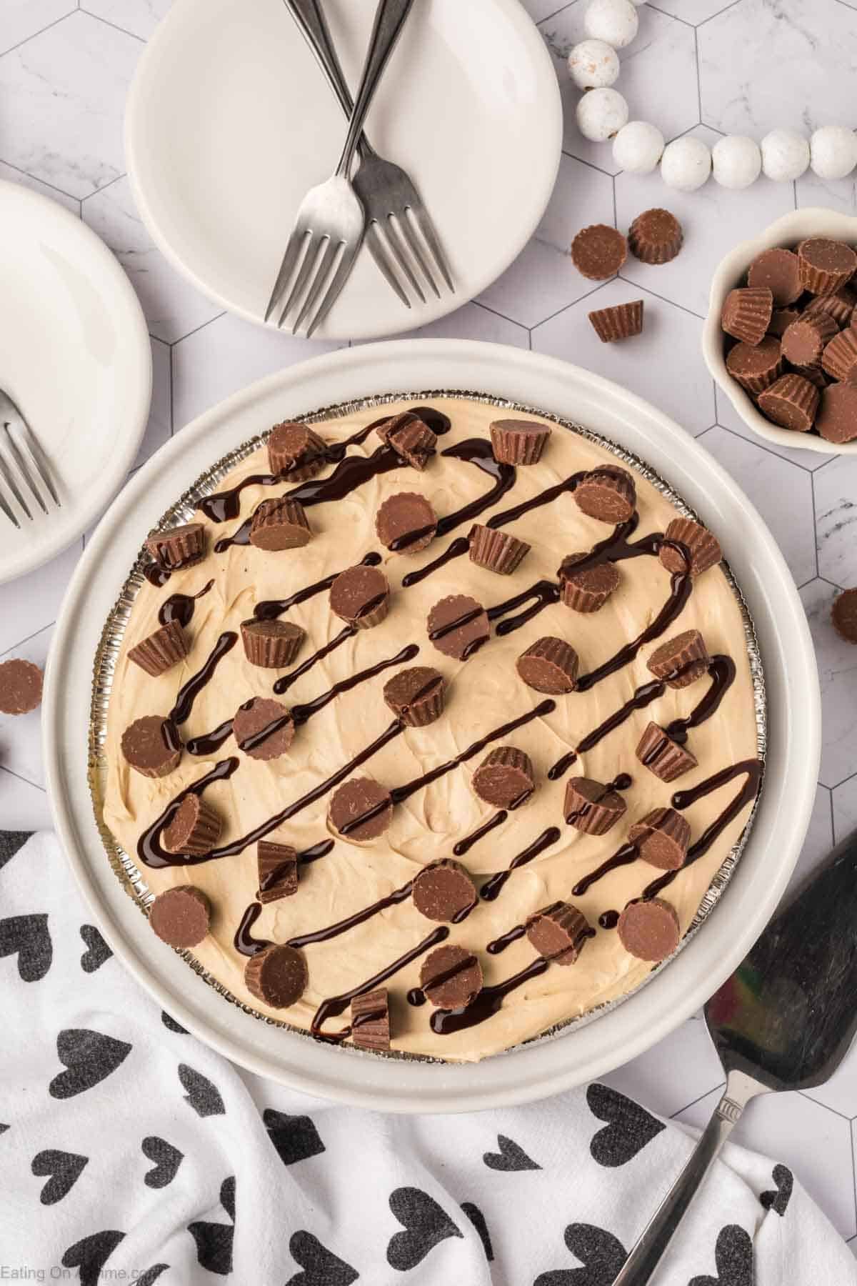 Chocolate and Peanut Butter pie topped with a drizzle of chocolate syrup and mini peanut butter cups