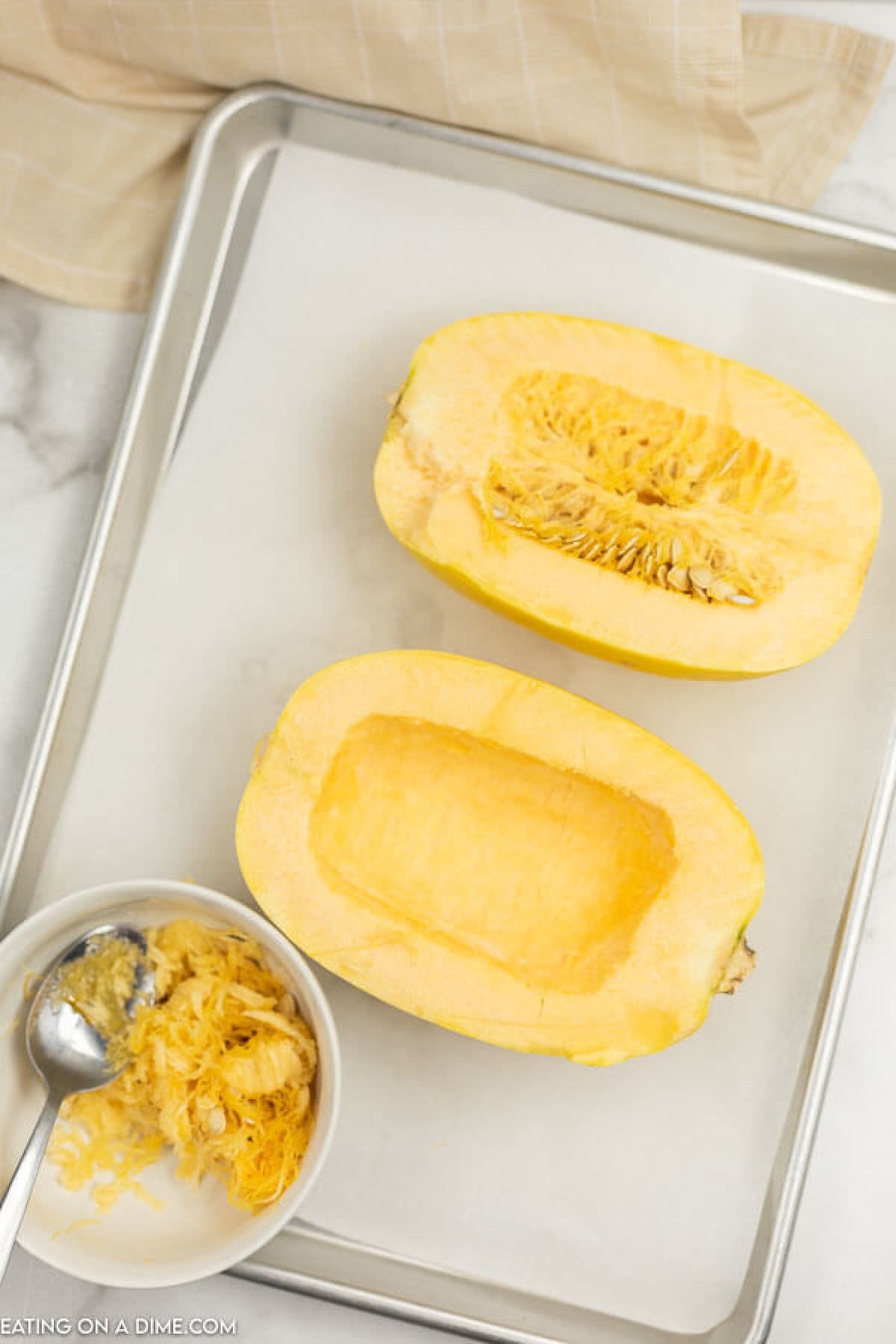The process of getting spaghetti squash ready to cook 