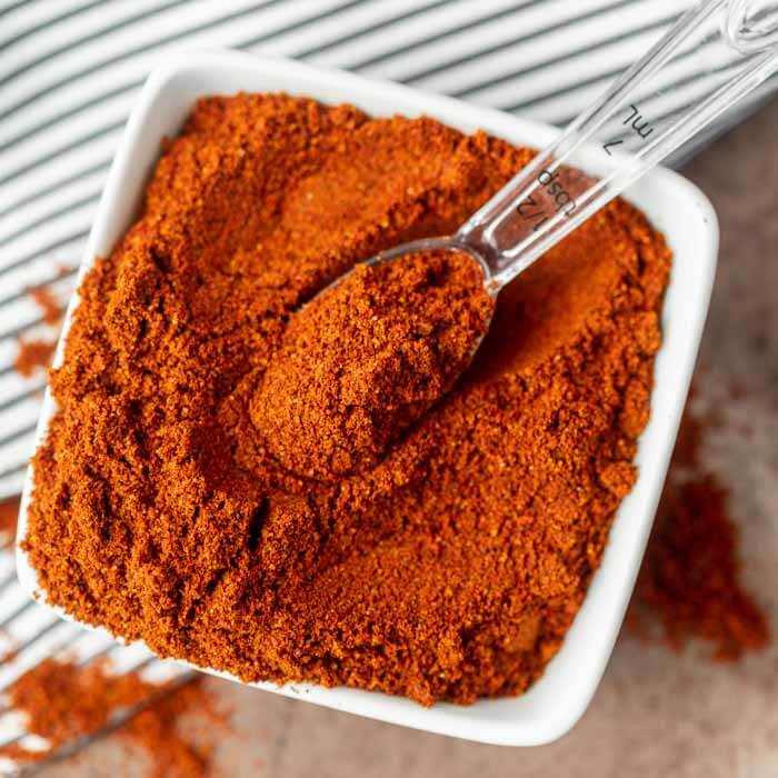 Close up image of Chili Powder in a white dish. 