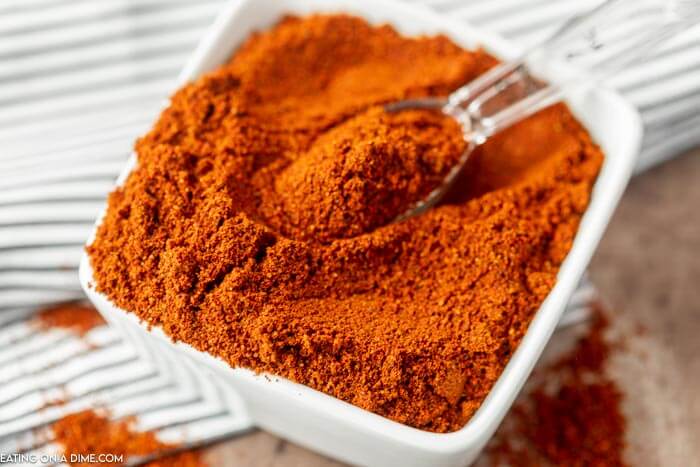 Close up image of Chili Powder in a white dish. 