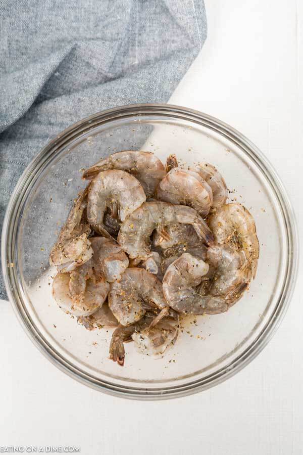 Shrimp in bowl with seasoning. 
