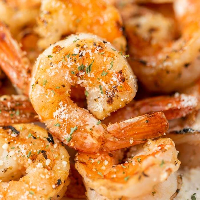 close up of a shrimp on a plate full of shrimp 