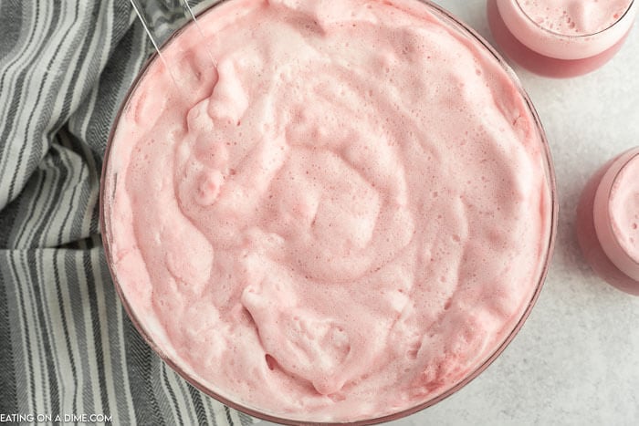 Close up image of raspberry sherbet punch in a punch bowl. 