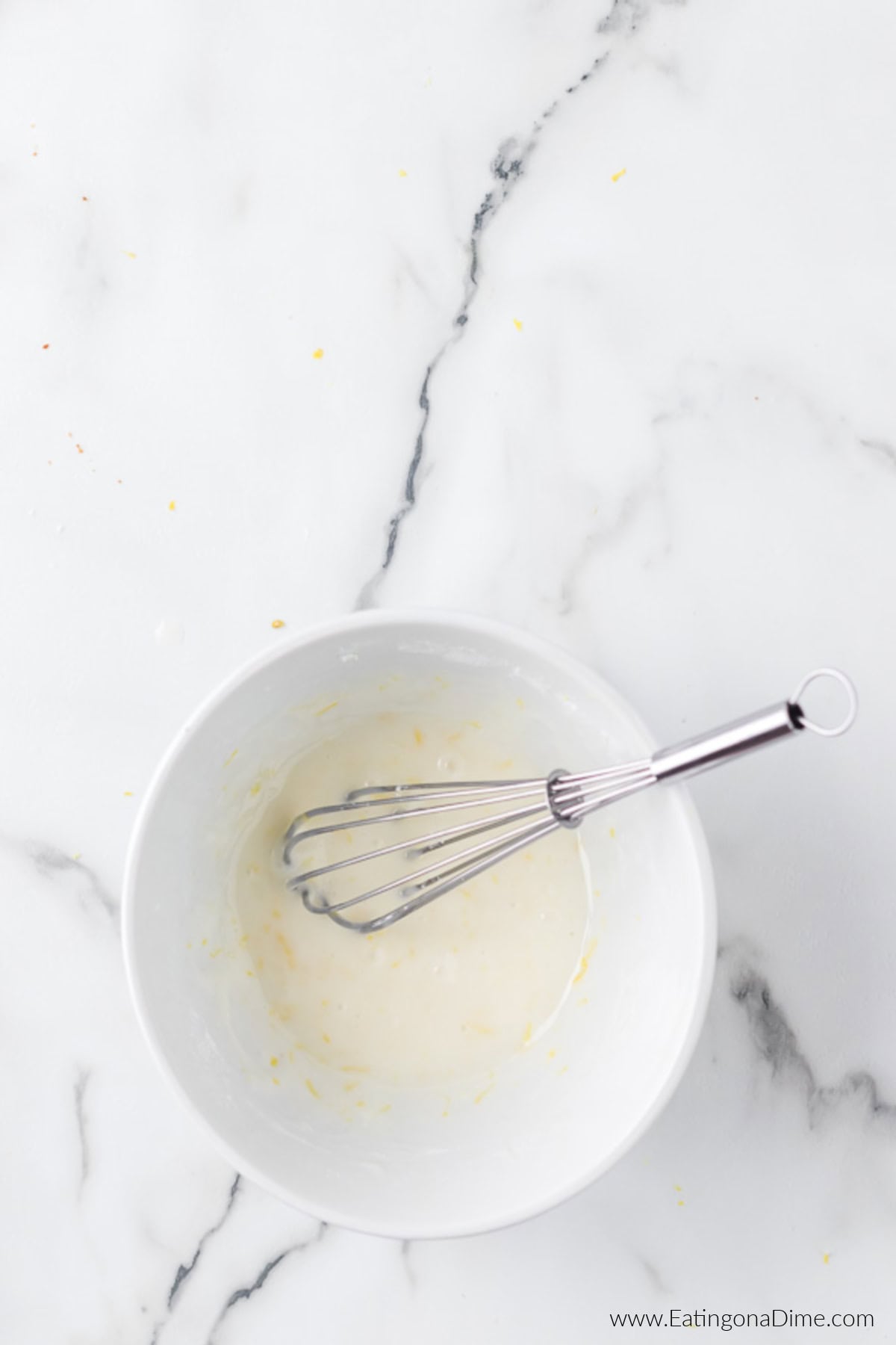 Glaze ingredients in a bowl with a whisk.