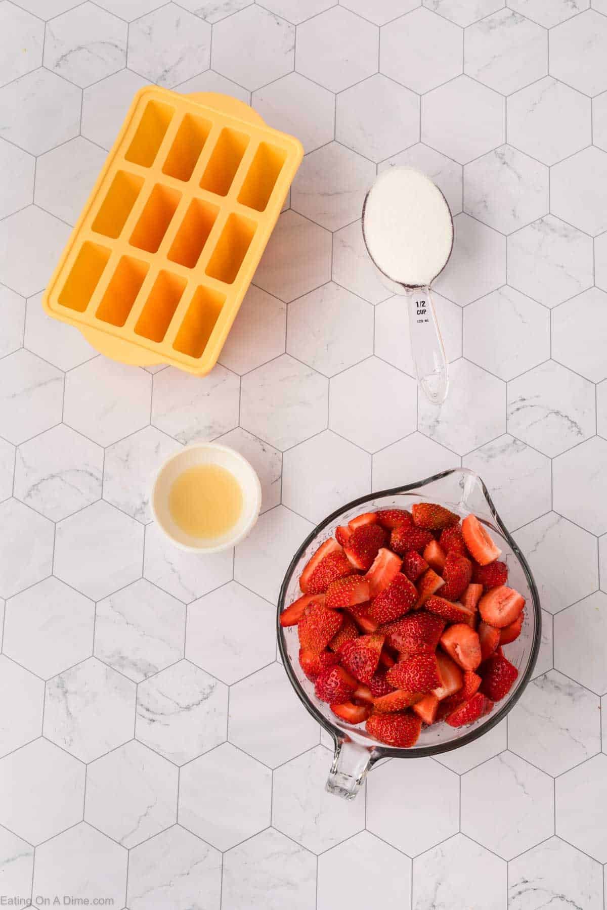 Ingredients - Diced strawberries, honey, sugar and popsicle molds