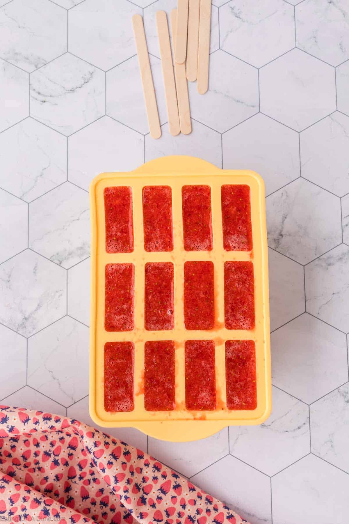 Strawberry mixture poured into the popsicle mold