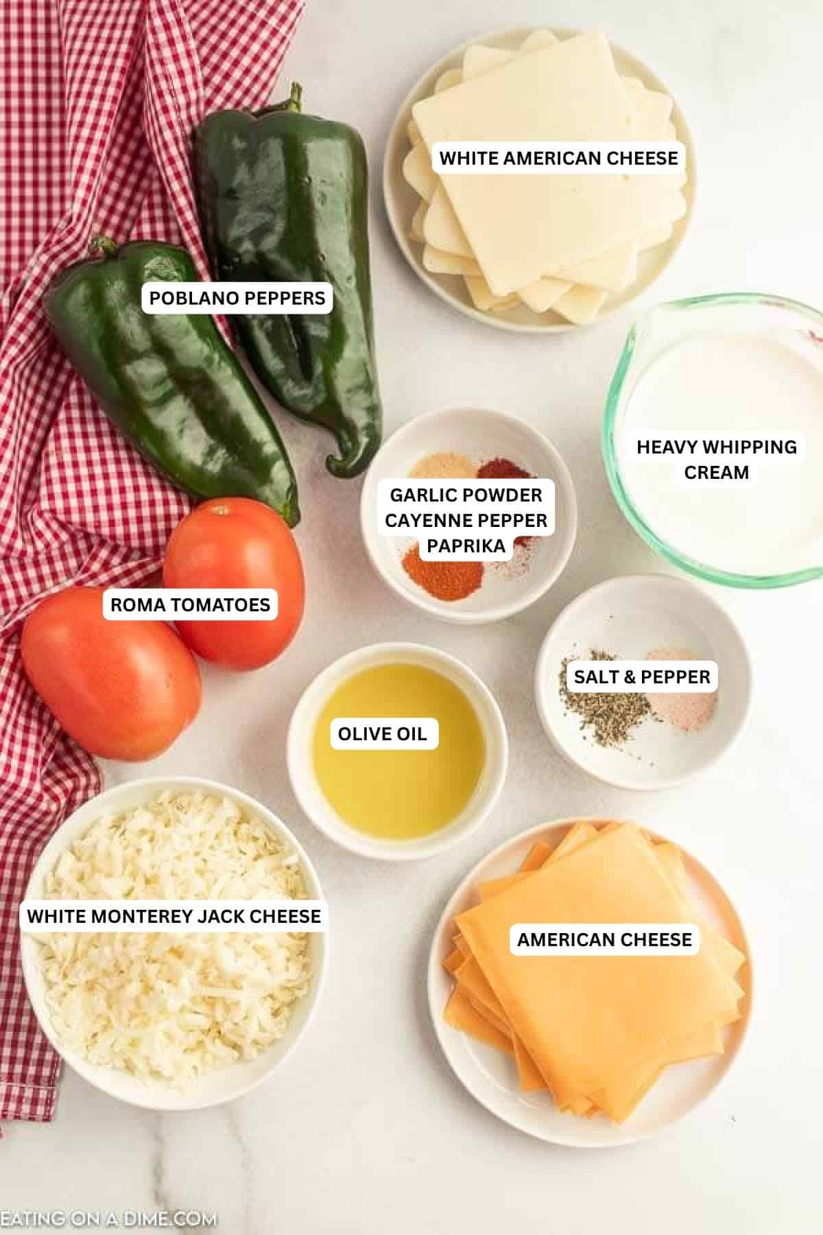 Ingredients for recipe: American cheese, white American cheese, white Monterey jack cheese, poblano peppers, Roma tomatoes, salt, pepper, heavy whipping cream, olive oil, paprika, cayenne paper and garlic powder.