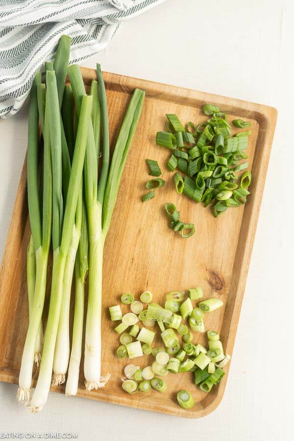 Close up image of green onions chopped on a cutting board