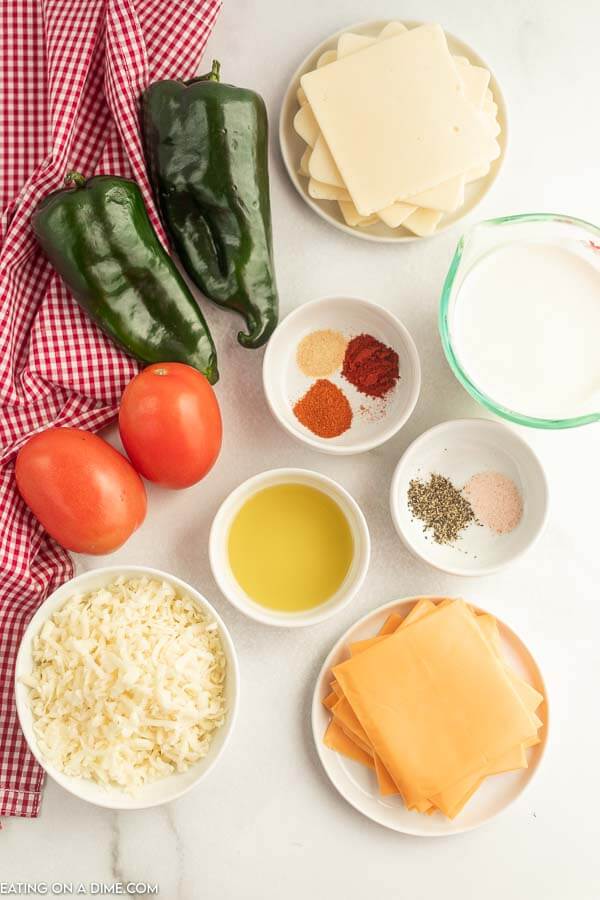 Ingredients needed - American Cheese, White American Cheese, White Monterey Jack Cheese, Poblano Peppers, Roma Tomatotes, salt and pepper, heavy whipping cream, olive oil, paprika, cayenne pepper, garlic powder