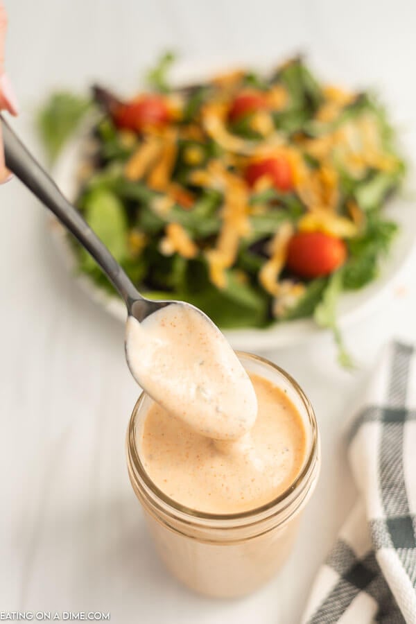 Close up image of Southwest Salad Dressing in a mason jar with a serving on a spoon. 